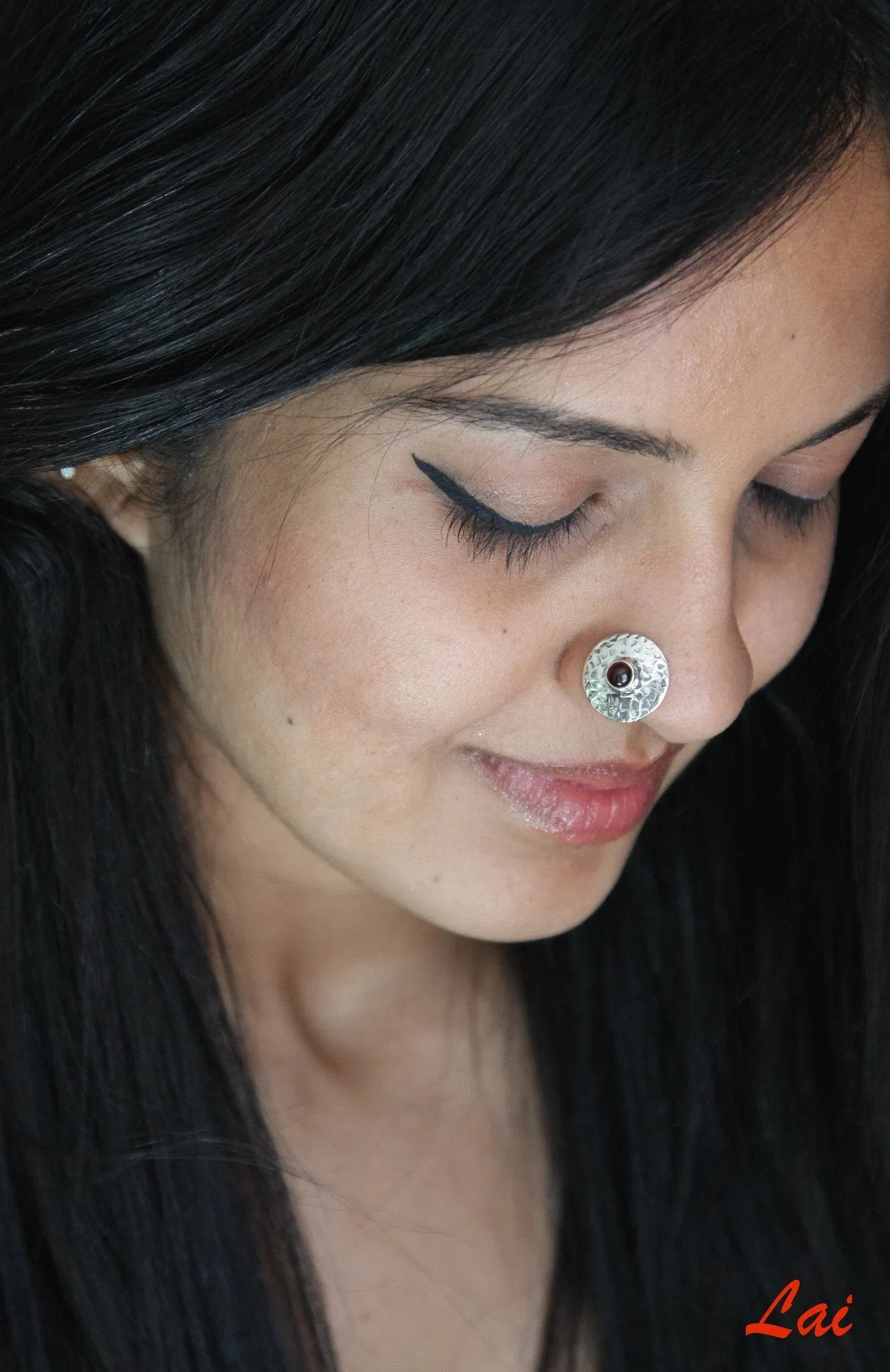 Big, round, textured nose pin with garnet center