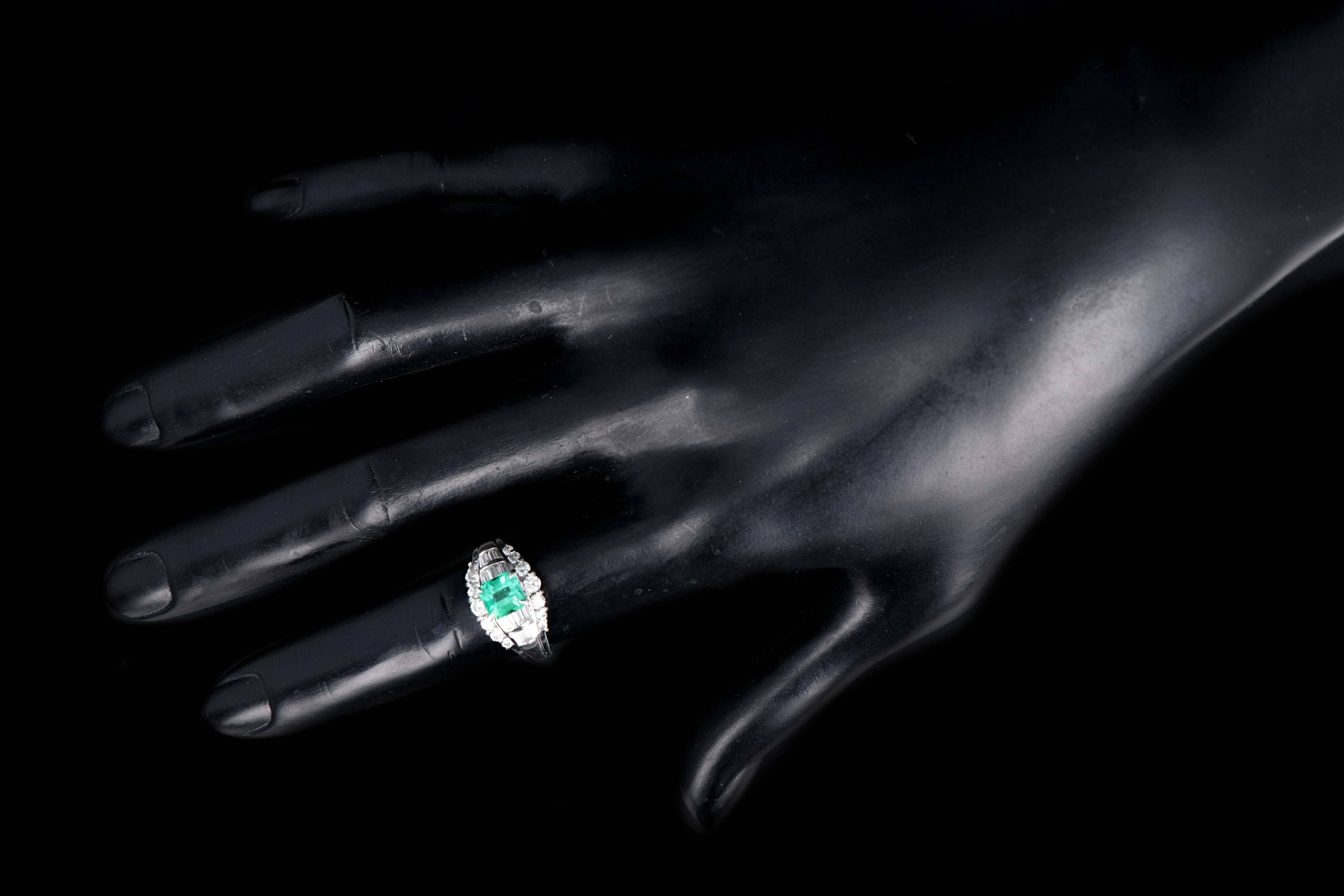 Retro Platinum .88 Carat Natural Emerald and Baguette Diamond Ring