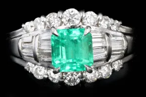 Retro Platinum .88 Carat Natural Emerald and Baguette Diamond Ring