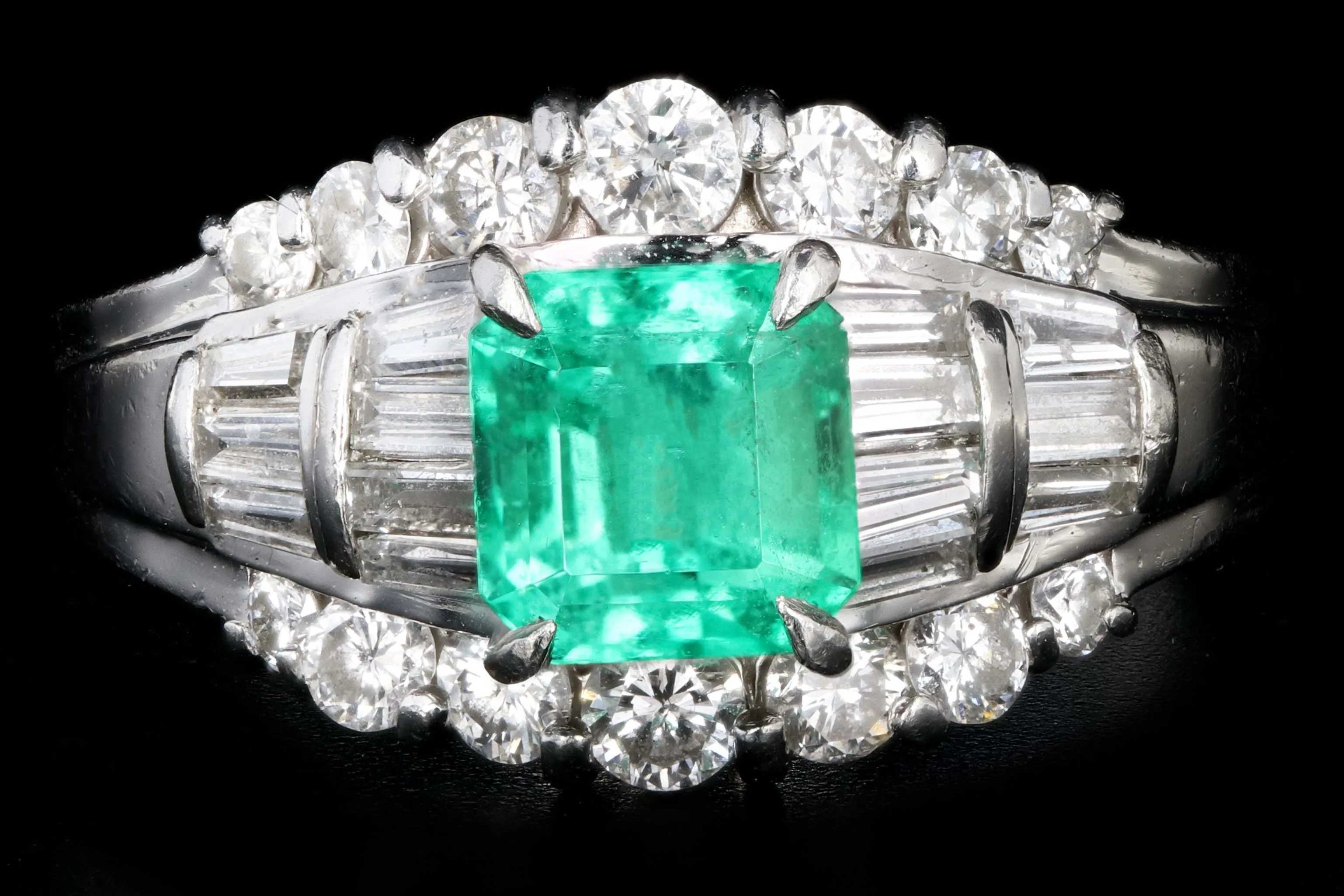 Retro Platinum .88 Carat Natural Emerald and Baguette Diamond Ring